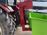 a tractor with a green box attached to it ' s back