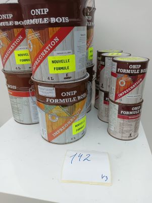 several buckets of paint sitting on top of a white table