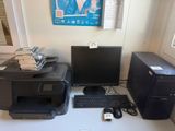 two computers and a printer sitting on a desk