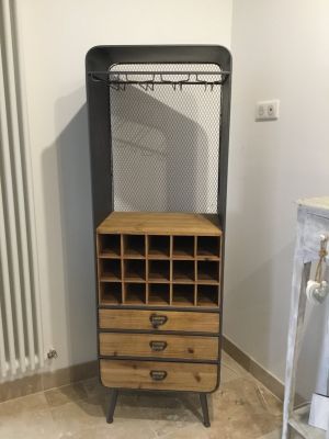 a wooden cabinet with drawers and a metal rack