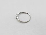 a close up of a silver ring on a white surface