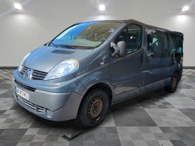 a silver van parked in a room with checkered floor
