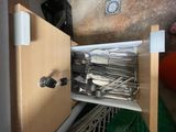 a cabinet with a bunch of silverware in it