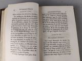 an open book on a table that has a picture of a cat on it