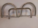 three stainless steel bars on a white surface