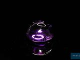 a glass vase with a purple light inside of it