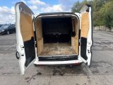 a white van with its doors open in a parking lot