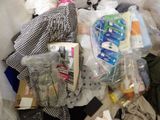 a pile of clothes and other items on the floor