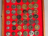 a picture of a display of coins in a wooden frame