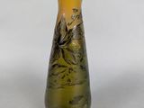 a yellow vase with a floral design on it
