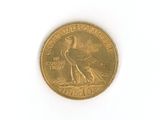 a gold coin with a bird on it on a white surface
