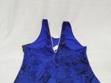 a close up of a blue tank top on a white sheet