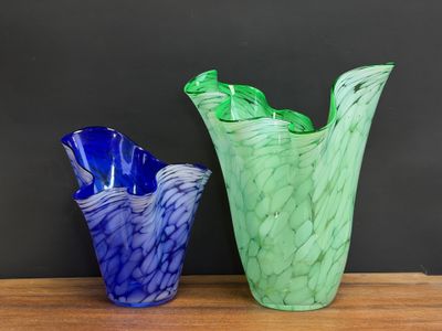 two vases that are sitting on a wooden table