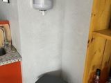 a box of pizza sitting on the floor next to a trash can