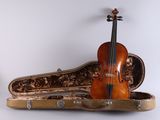 a violin sitting in a case on a white surface