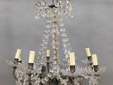 an antique crystal chandelier with four lights hanging from the ceiling
