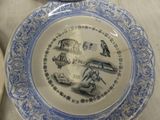 a blue and white plate with a picture of a bird on it