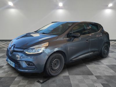 a grey car parked in a garage with a checkered floor