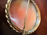 a picture of a broocht on a wooden table