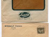 two envelopes with stamps on them are sitting next to each other