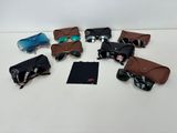 several pairs of sunglasses are laid out on a white surface