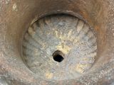 a close up view of a rusted vase with a hole in it