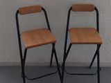two chairs in the corner of a room next to a window