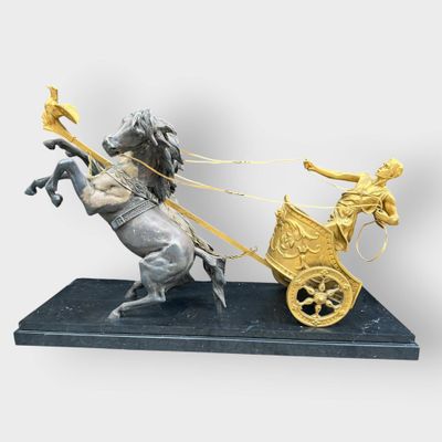 statue of a man on a horse pulling a cart with a woman on it