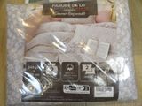 packaging of a blanket and pillow in a plastic bag on a table