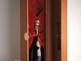a bottle of champagne in a wooden box with a red ribbon