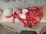 a white hat and a red and blue dress on a table