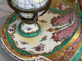 a plate with a globe on top of it on a stand
