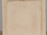 an image of a white plate on a wooden stand on a table