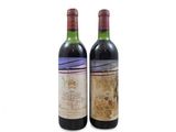two bottles of wine sitting next to each other on a white surface