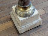 a vase that is sitting on a pedestal on the floor