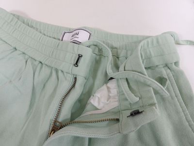 mint green sweat pants with zipper pockets and zippered cuffs