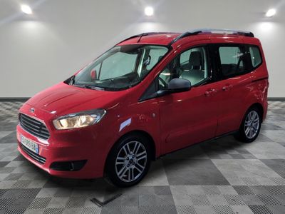 a red van parked in a garage with a checkered floor