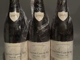 three bottles of wine wrapped in plastic sitting on a table