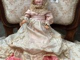 a doll that is sitting on a chair