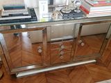 a glass table with books and a lamp on it