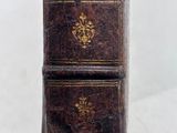 a close up of a book on a white surface with a white background