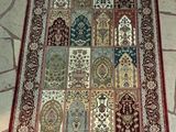 a rug on the floor that has many different designs on it