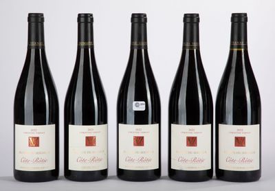 four bottles of wine are lined up in a row
