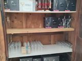a wooden cabinet with wine glasses on top of it