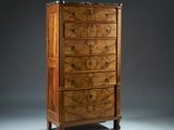 an antique walnut chest of drawers with marble top