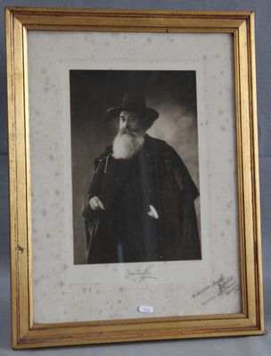 an old photo of a man with a long beard and a hat