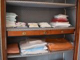 a wooden cabinet with many items on top of it