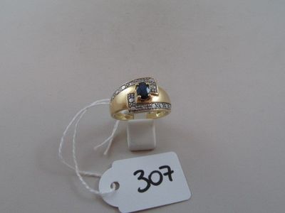 a gold ring with a blue stone on top of it