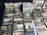 a lot of old postcards sitting on a table
