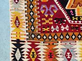 a close up of a colorful rug on a blue surface